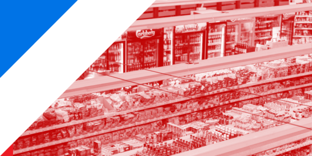 The interior of a supermarket; you can see the shelves filled with food and drink.